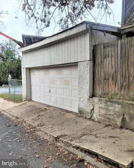 detached garage featuring fence
