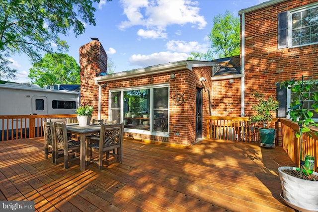 wooden deck featuring outdoor dining space