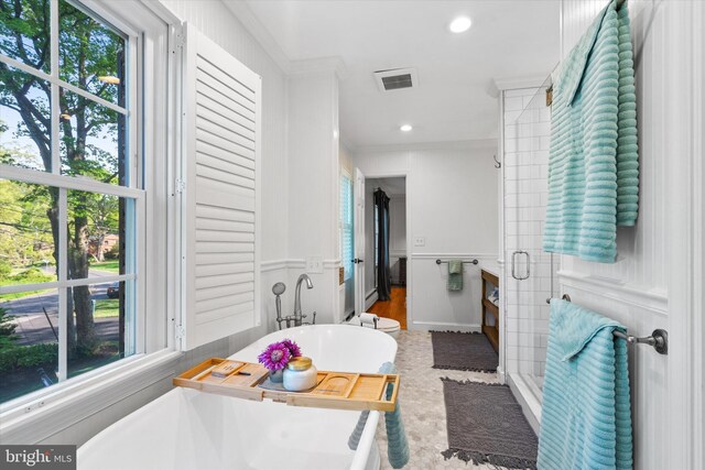 bathroom featuring visible vents, a shower stall, plenty of natural light, and a freestanding bath