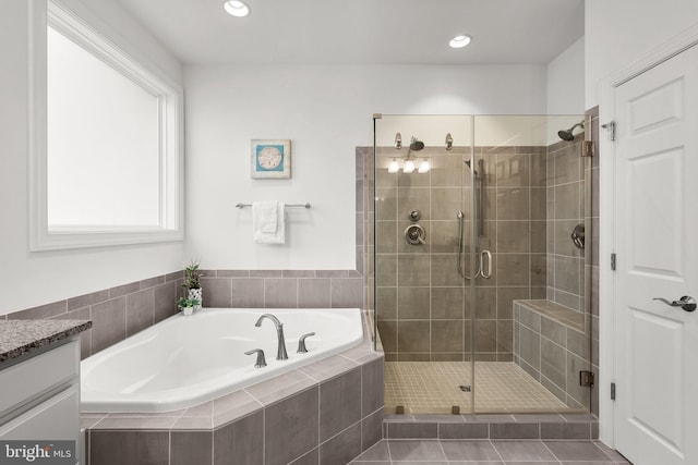 bathroom featuring a bath, a shower stall, vanity, and recessed lighting