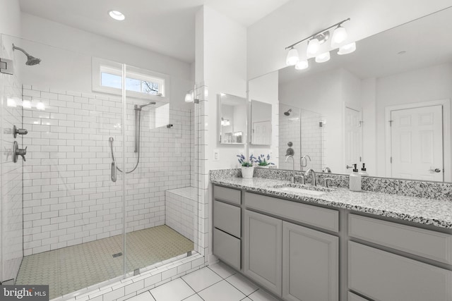bathroom featuring vanity, tile patterned flooring, and a shower stall