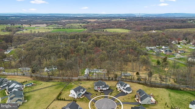 birds eye view of property featuring a wooded view