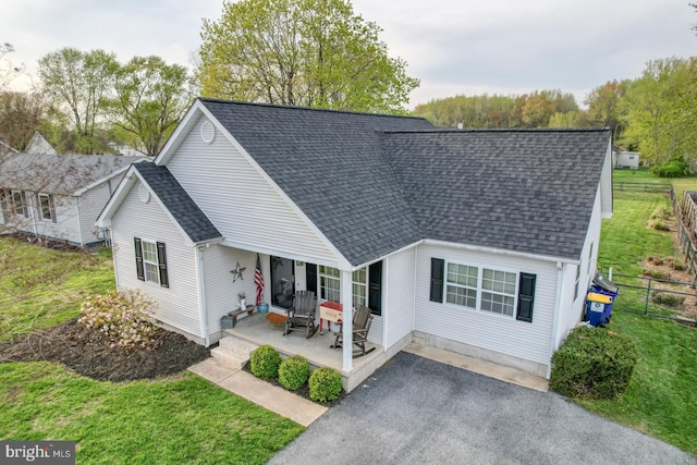 415 W High St, Felton, DE 19943 - view of front facade with fence, covered porch, a shingled roof, and a front lawn