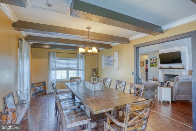 415 W High St, Felton, DE 19943 - dining room featuring wood finished floors, beamed ceiling, ornamental molding, a fireplace, and a notable chandelier