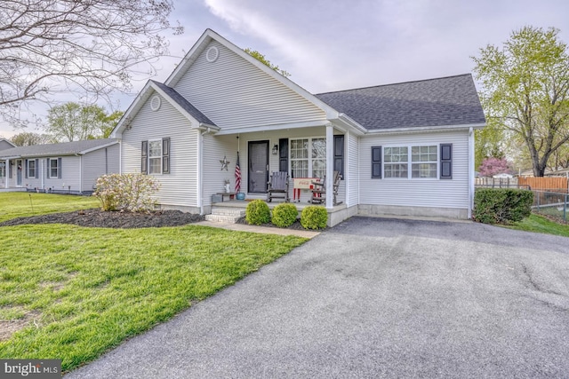 415 W High St, Felton, DE 19943 - ranch-style house featuring a porch, a front lawn, fence, and roof with shingles