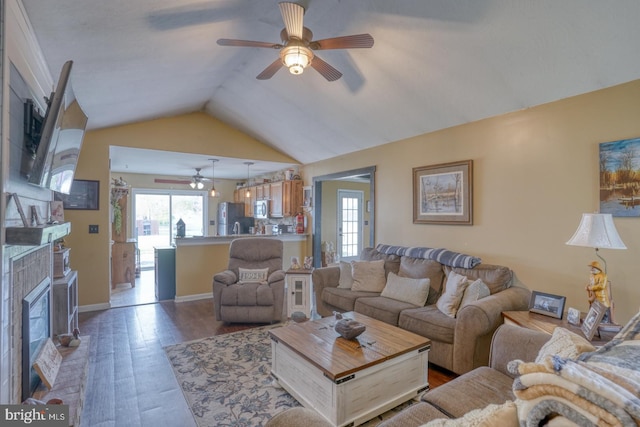 415 W High St, Felton, DE 19943 - living room with lofted ceiling, ceiling fan, wood finished floors, and a fireplace