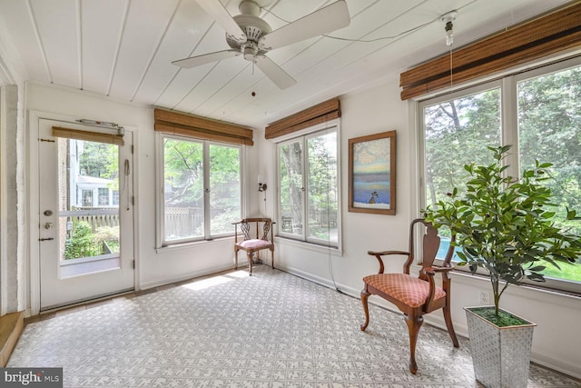 sunroom / solarium with carpet flooring and baseboards