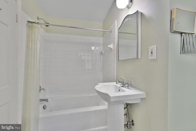 bathroom with shower / bath combination with curtain