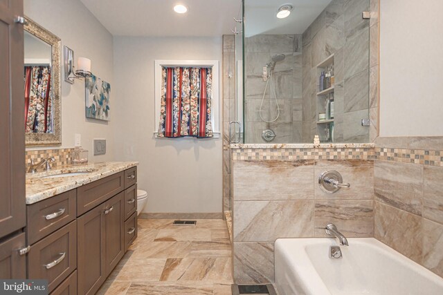 full bathroom with vanity, a shower with door, a tub, visible vents, and recessed lighting