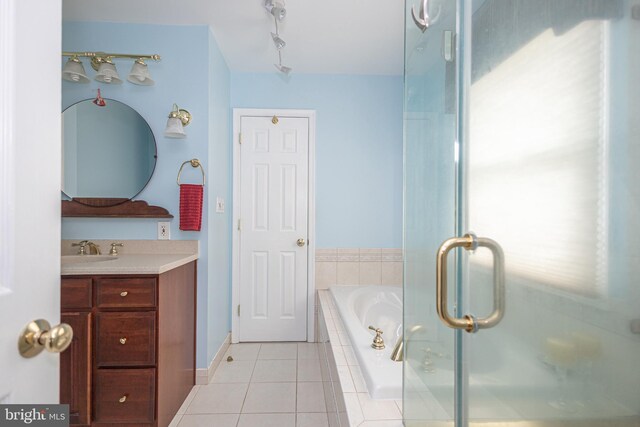 bathroom featuring a garden tub, vanity, tile patterned flooring, and a shower stall