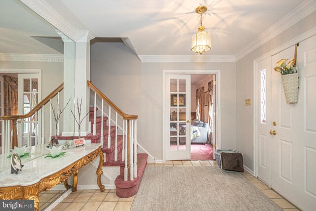 entrance foyer with ornamental molding, light tile patterned floors, baseboards, stairs, and a notable chandelier