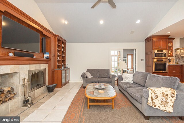 living area with recessed lighting, a tile fireplace, vaulted ceiling, light tile patterned floors, and ceiling fan