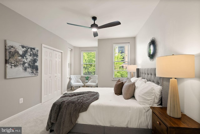 bedroom featuring a ceiling fan, baseboards, carpet floors, and a closet