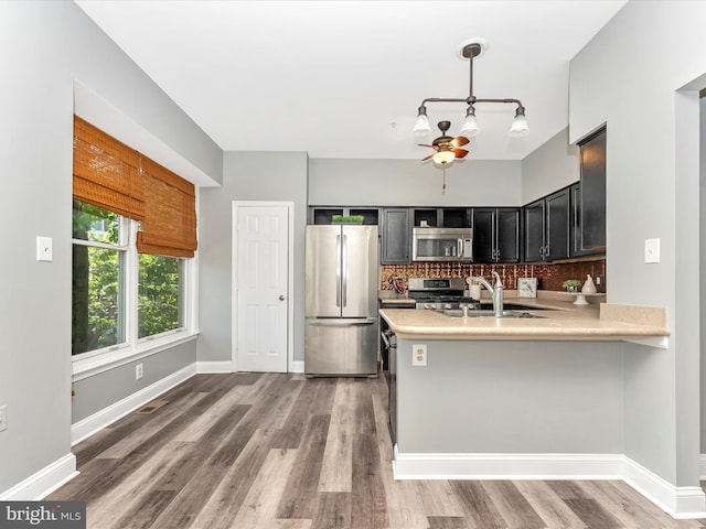 109 Rock Creek Ct, Frederick, MD 21702 - kitchen featuring a sink, ceiling fan, stainless steel appliances, light countertops, and backsplash