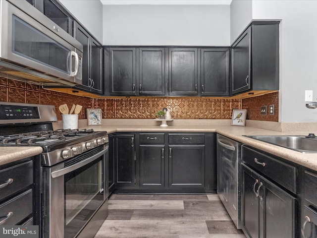 109 Rock Creek Ct, Frederick, MD 21702 - kitchen with tasteful backsplash, light countertops, appliances with stainless steel finishes, and light wood finished floors