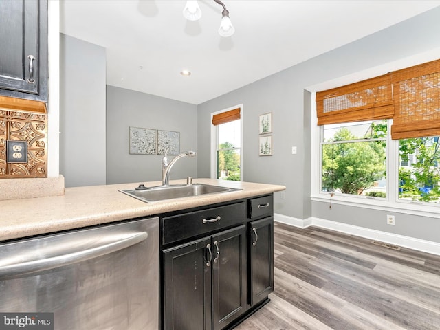 109 Rock Creek Ct, Frederick, MD 21702 - kitchen with stainless steel dishwasher, light wood-style flooring, a sink, baseboards, and visible vents