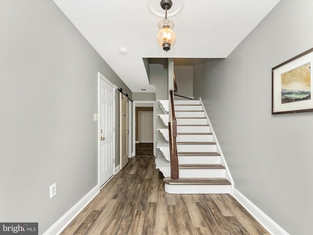 109 Rock Creek Ct, Frederick, MD 21702 - stairway featuring baseboards, a barn door, and wood finished floors