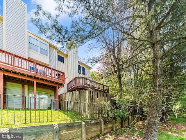 109 Rock Creek Ct, Frederick, MD 21702 - rear view of property featuring fence, a chimney, a yard, and a wooden deck