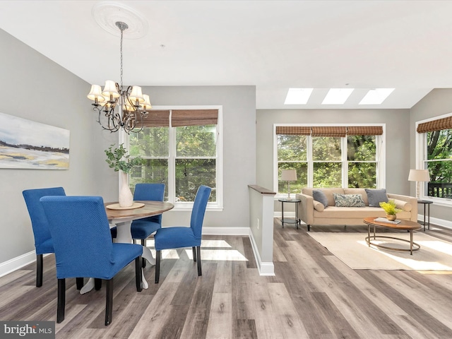 109 Rock Creek Ct, Frederick, MD 21702 - dining room with baseboards, wood finished floors, and a chandelier