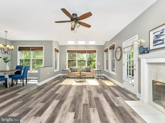 109 Rock Creek Ct, Frederick, MD 21702 - living area with ceiling fan with notable chandelier, a fireplace with flush hearth, wood finished floors, and baseboards