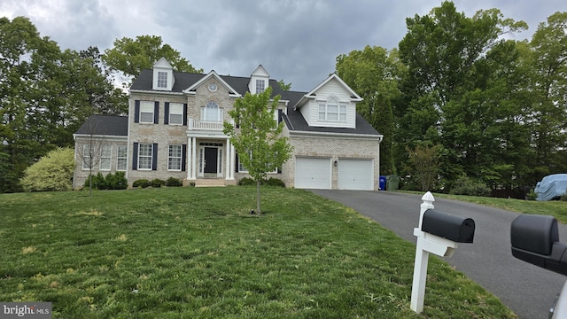 4222 Berkley Ct, King George, VA 22485 - colonial house featuring brick siding, driveway, a front lawn, and a garage