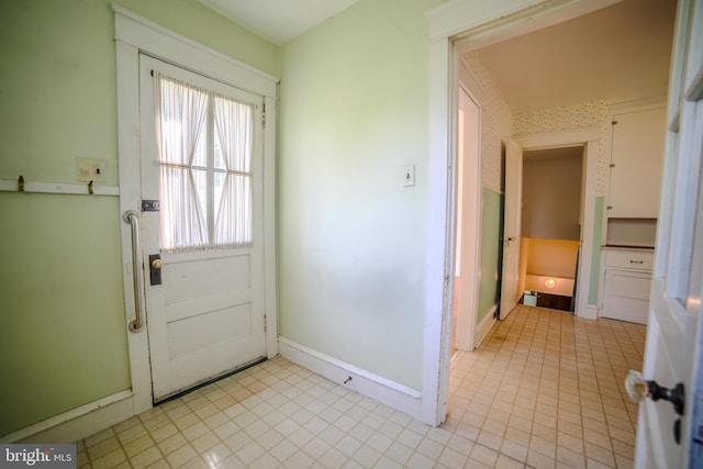 entryway featuring light tile patterned floors and baseboards