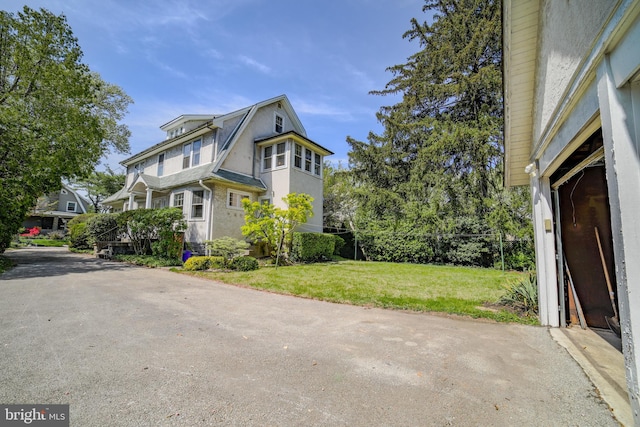 view of side of property featuring a yard and stucco siding