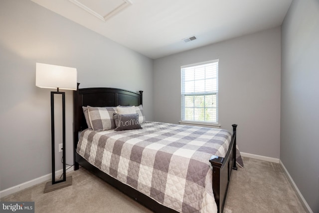 carpeted bedroom featuring baseboards and visible vents