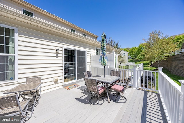 wooden deck featuring outdoor dining space