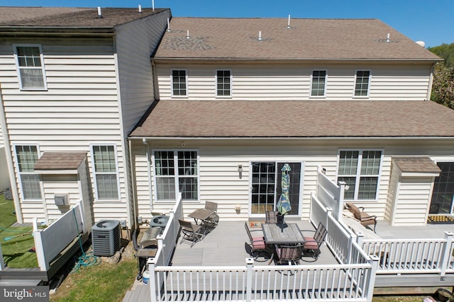 rear view of property with roof with shingles, central AC, a deck, and outdoor dining space