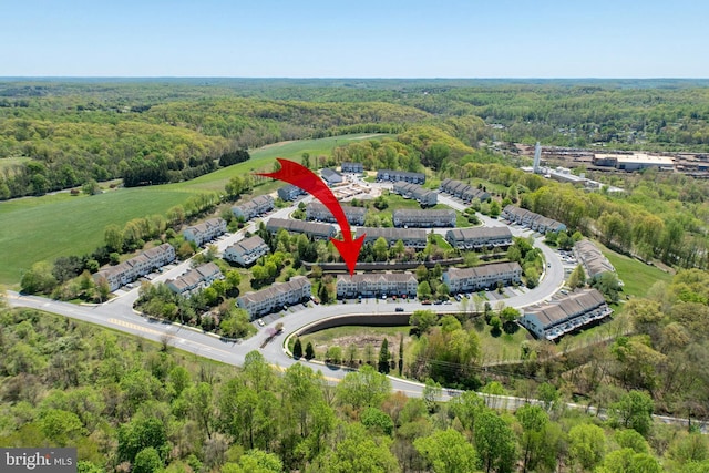 birds eye view of property with a forest view