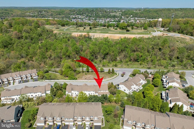drone / aerial view with a residential view and a forest view