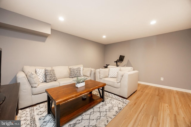 living area with recessed lighting, light wood finished floors, and baseboards