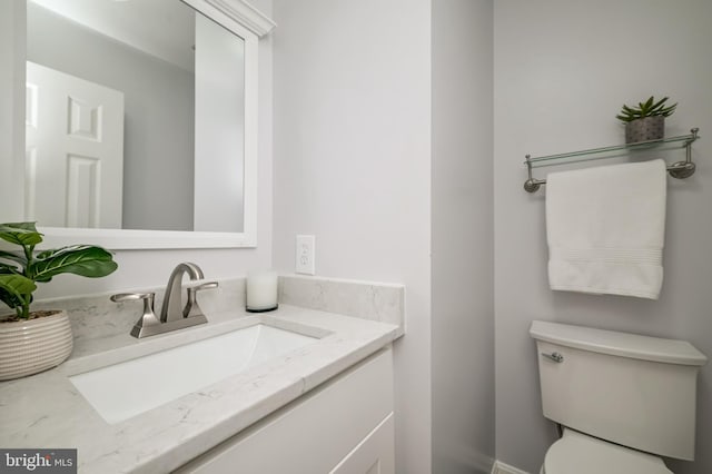 bathroom featuring toilet and vanity
