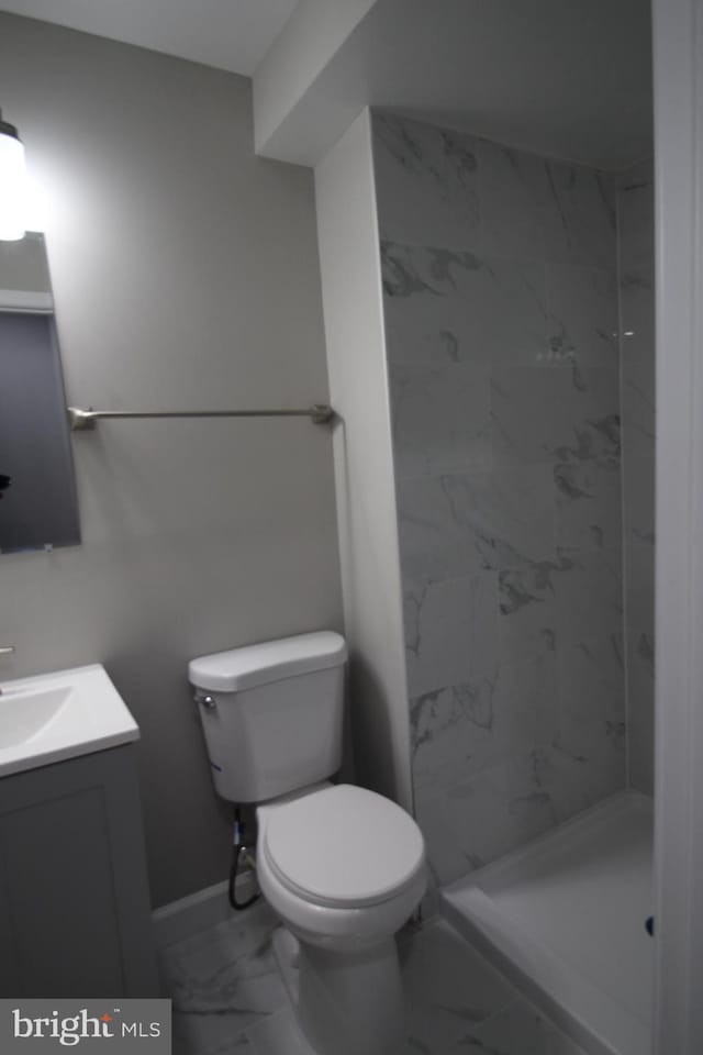 1029 Kings Ct, Herndon, VA 20170 - bathroom with marble look tile flooring, vanity, toilet, and a shower stall