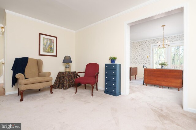 sitting room with a chandelier, crown molding, baseboards, and carpet floors