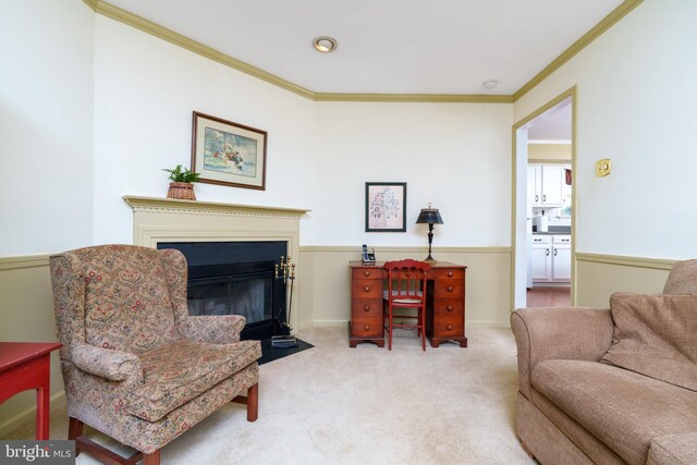 living area with a fireplace with flush hearth, carpet, and crown molding