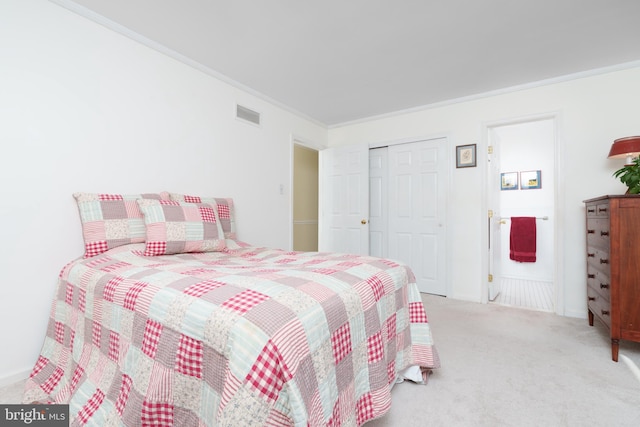 bedroom featuring ornamental molding, a closet, visible vents, and carpet