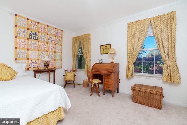 bedroom featuring baseboards, ornamental molding, and carpet