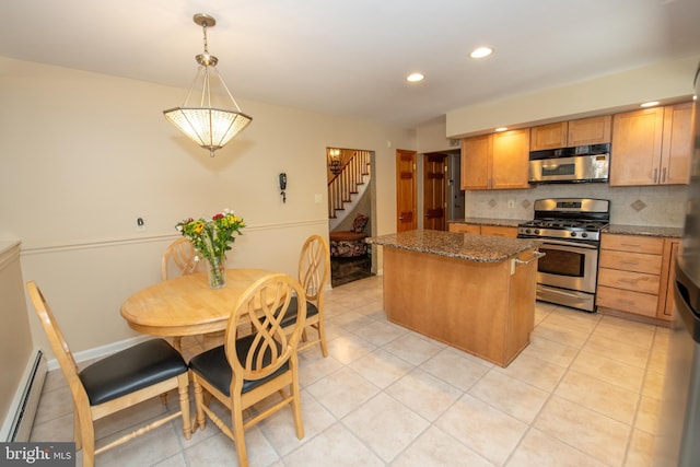 kitchen with a center island, tasteful backsplash, light tile patterned floors, a baseboard radiator, and stainless steel appliances