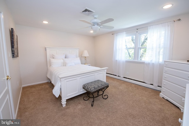 bedroom with light carpet, a baseboard heating unit, recessed lighting, and visible vents