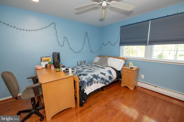 bedroom featuring ceiling fan, wood finished floors, baseboards, a baseboard heating unit, and recessed lighting