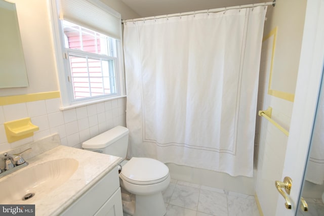 full bathroom featuring vanity, toilet, shower / bath combination with curtain, marble finish floor, and tile walls