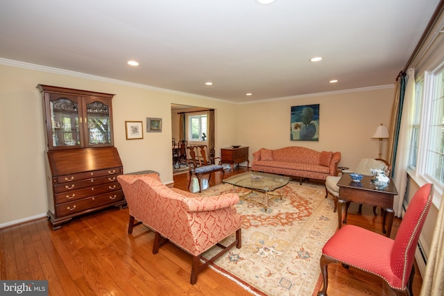 living area featuring crown molding, baseboards, recessed lighting, and wood finished floors