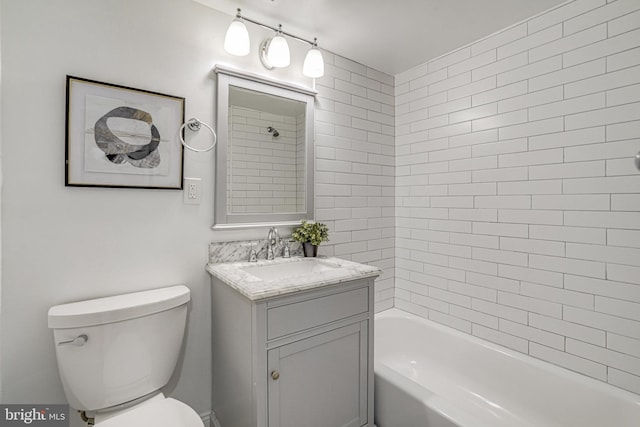 bathroom with vanity, shower / bathtub combination, and toilet
