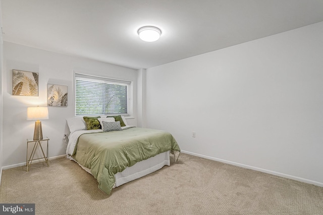 bedroom featuring carpet floors and baseboards