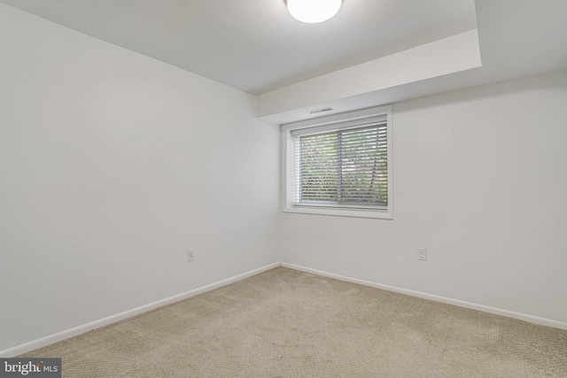 empty room with baseboards, visible vents, and light colored carpet