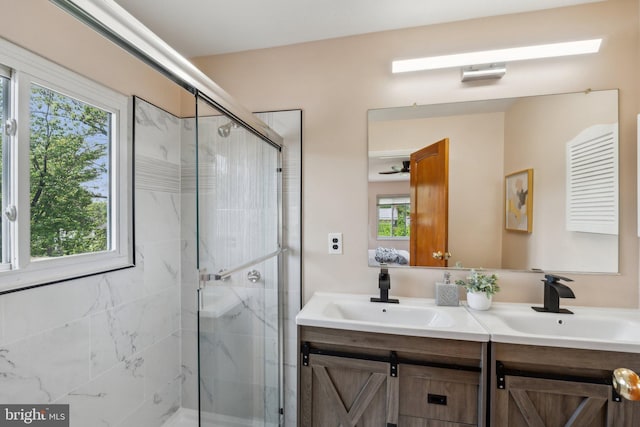 full bathroom featuring a shower stall, a healthy amount of sunlight, and a sink