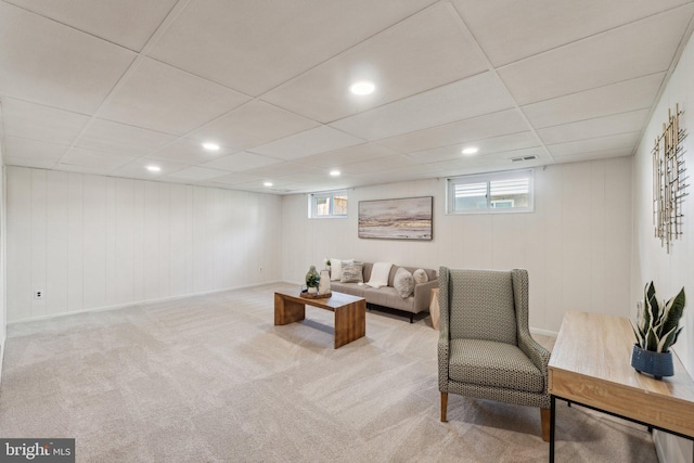 living area with a drop ceiling, light carpet, and recessed lighting