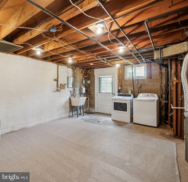 basement with independent washer and dryer and a sink